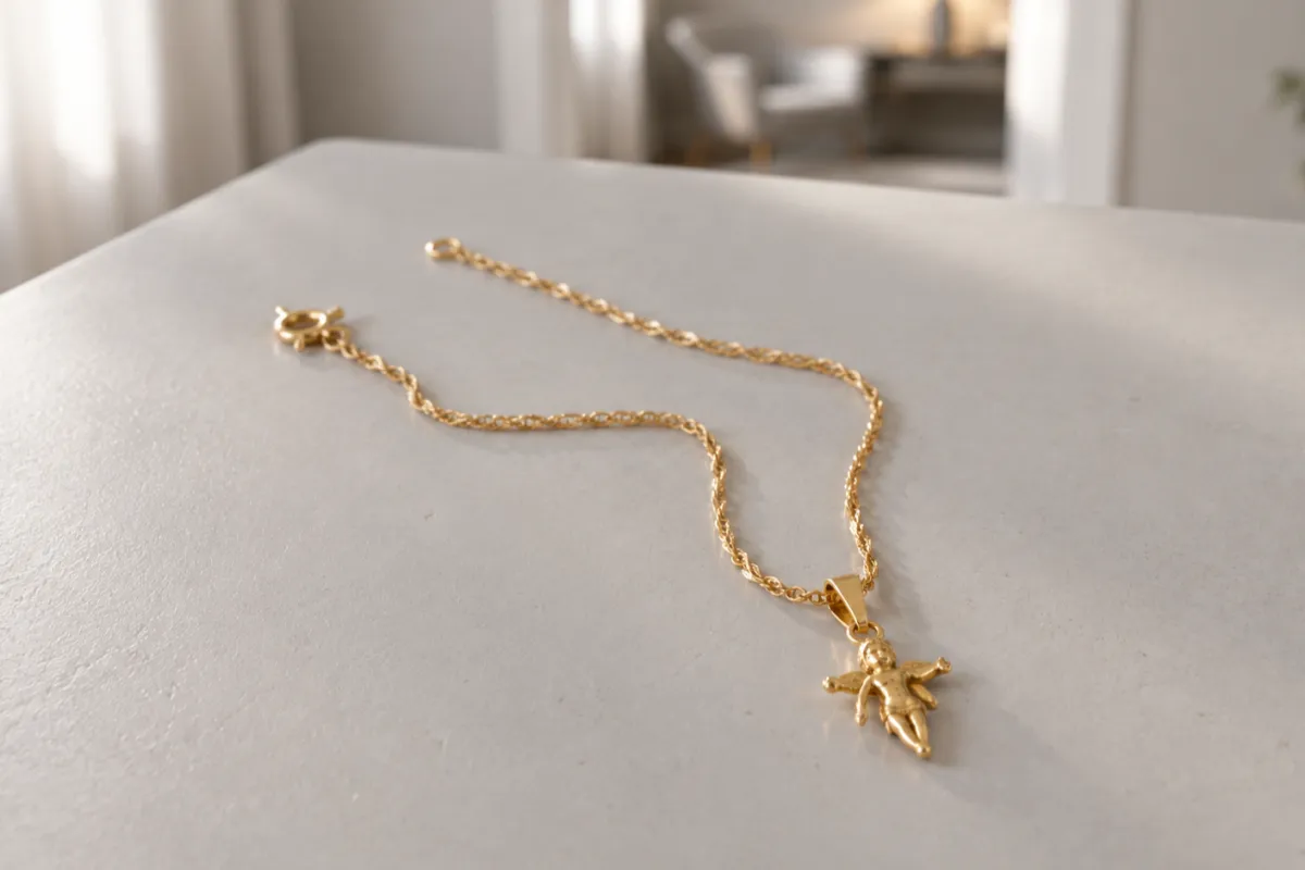 Dopsmycke i guld i guld som ligger på ett ljust bord